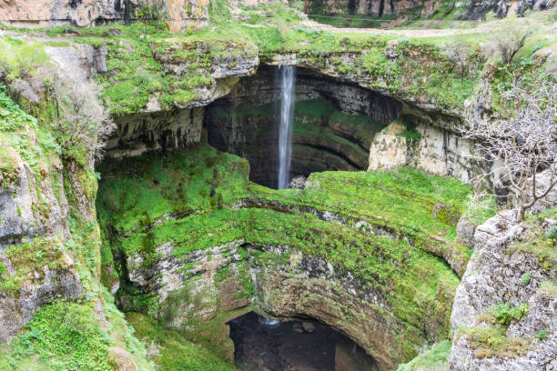 istock Waterfall behind a natural bridge, Baatara gorge waterfall 1316268652
