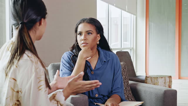 Vulnerable woman talks with mental health professional