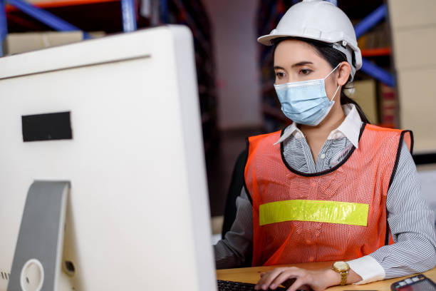 istock Engineer woman wearing a hardhat standing cargo at goods or merchandise warehouse and check control loading from Cargo freight ship for import and export. Teamwork successful concept. 1316269109