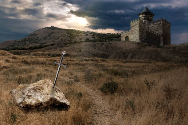 sword of King Arthur A collage on the theme of the legend of King Arthur and his sword Excalibur, sunk in stone. The image of the castle on the hill is a composite collage and is not a photo of a real castle. merlin the wizard stock pictures, royalty-free photos & images
