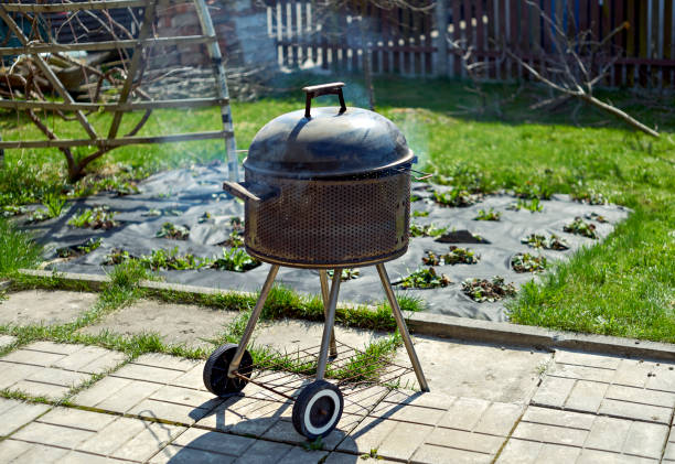 istock Barbeque grill in the blurred spring garden background. Selective focus on barbeque grill. 1316270799