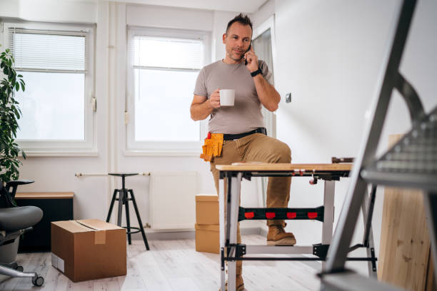 istock a man drinking coffee and making a phone call during a renovation break 1316271393