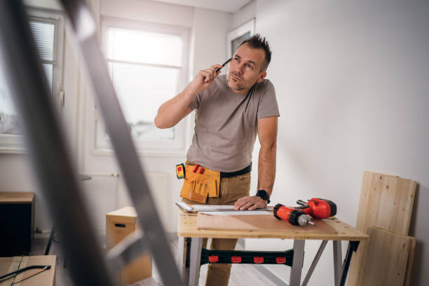 istock Good-looking male carpenter talking on the phone with a customer 1316272087