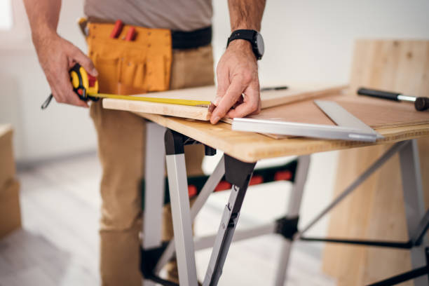 istock Professional carpenter at work measuring wooden planks 1316272182