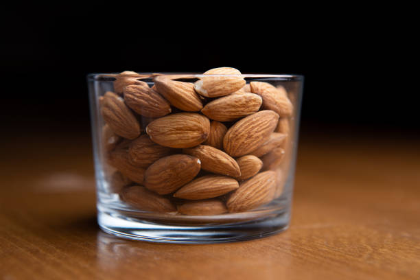 istock Almonds in clear glass on a table 1316272283