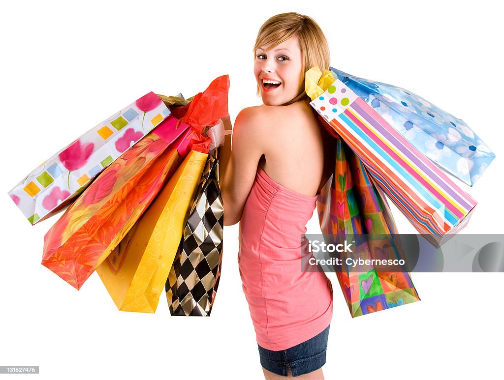 Young Woman on a Shopping Spree A proud young woman is coming back from a shopping spree. Adolescence Stock Photo