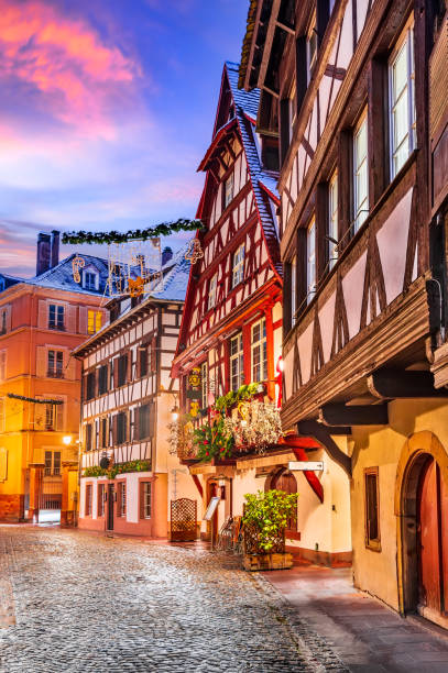 Petite France in Strasbourg - Alsace, France Strasbourg, France. Traditional Alsace half-timbered houses in Petite France during twilight decorated  at Christmas time. petite france strasbourg stock pictures, royalty-free photos & images