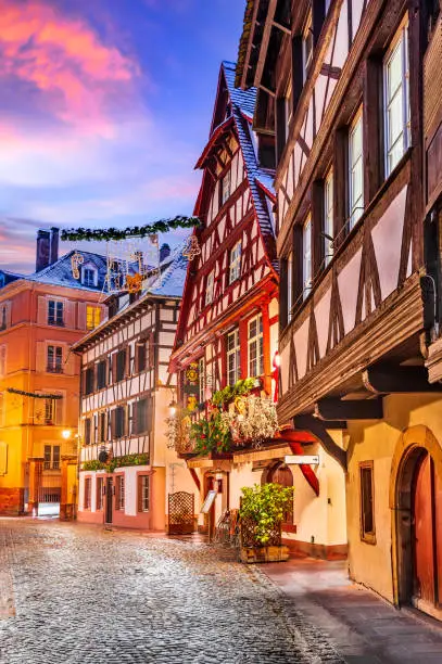 Strasbourg, France. Traditional Alsace half-timbered houses in Petite France during twilight decorated  at Christmas time.