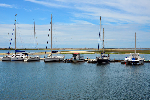 Olhao, Faro District, Portugal: boats moored in the marina, Coco and Culatra islands in the background - Ria Formosa nature park.
