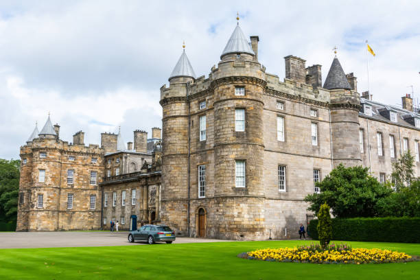 Palace of Holyroodhouse in Edinburgh, Scotland. Edinburgh, United Kingdom - September 8, 2017. Palace of Holyroodhouse in Edinburgh. The palace is the royal family"u2019s official residence in Scotland. Exterior view with people and car. midlothian scotland stock pictures, royalty-free photos & images