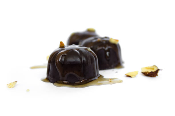 istock chocolate candies with melted chocolate macro isolated on a white background 1316278280