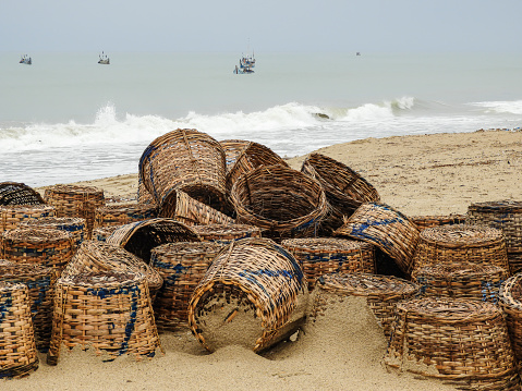 Fishing baskets lying on the beach in Ada Foah ghana west Africa