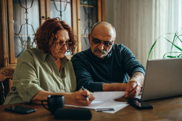 istock Senior couple doing some paperwork at home 1316280803