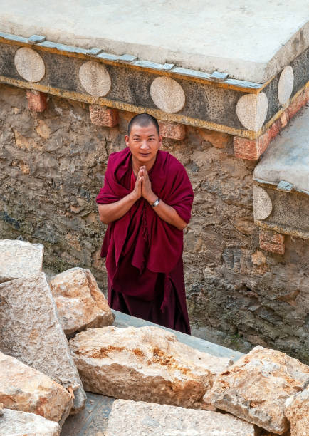 Tibetan Monk Portrait, Tibetan monk doing reverence in Songzanlin monastery, also known as Ganden Sumtseling Gompa in Zhongdian, Shangri La, Yunnan province. yunnan province stock pictures, royalty-free photos & images