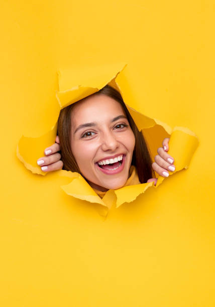 istock Friendly female ripping yellow paper 1316282228