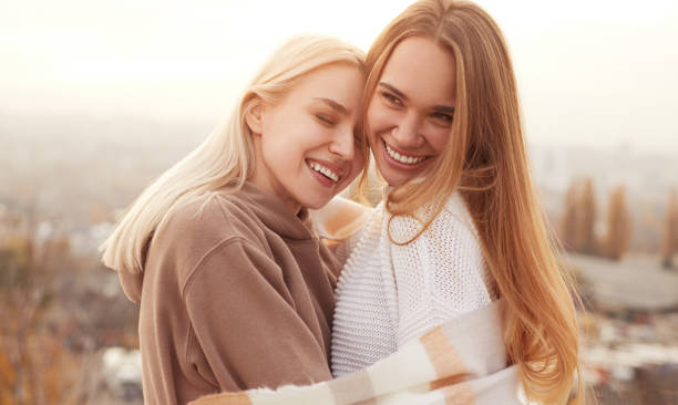 istock Happy girlfriends hugging in countryside 1316282319