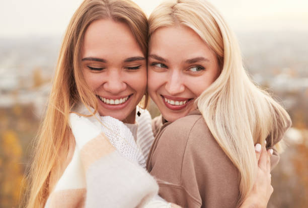 istock Happy girlfriends hugging on street 1316282337