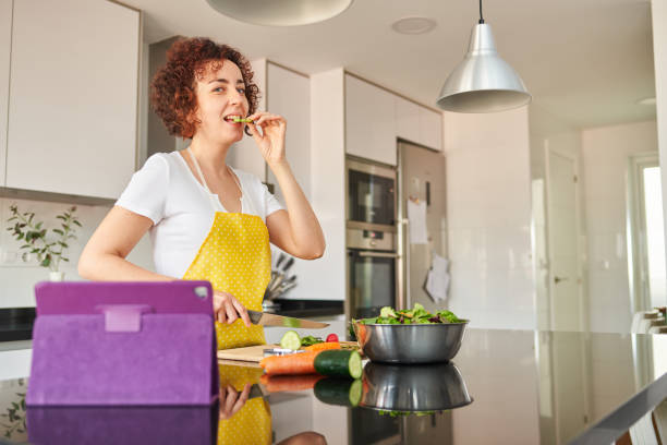 istock Woman in the kitchen making a salad 1316285963