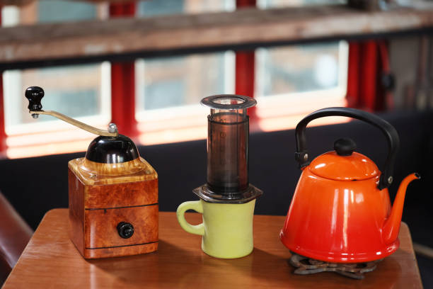 istock accessory  of coffee press (French press) handcoffee grinder kettle and cup. process at home selective focus blur background with copy space 1316286152