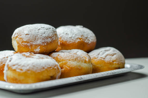 istock Berliner Pfannkuchen, a German donut, traditional yeast dough deep fried filled with chocolate cream and sprinkled with powdered sugar 1316294003