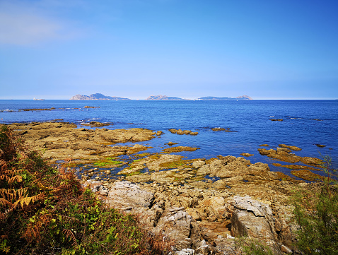 rock beach in the Atlantic sea with Cies Islands near Vigo, Galicia, Spain