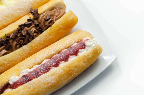 istock Mixed finger donuts filling chocolate, custard, jam and whipped cream, eclairs in different flavors 1316295112