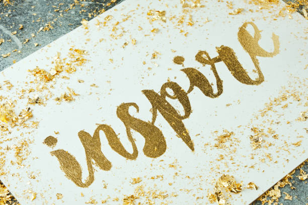 istock Inspire. Motivating lettering on white board. Handmade creativity. Gold letters. Gilding. 1316295163