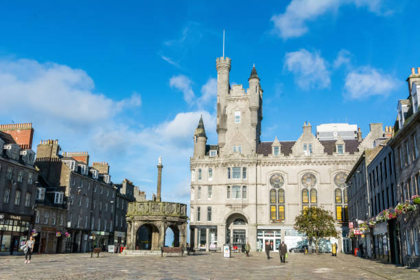 Castle street in Aberdeen, Scotland Aberdeen, United Kingdom - September 14, 2017. Castle street in Aberdeen, Scotland, with the Salvation Army Citadel and Mercat Cross. View with people and commercial properties on a sunny day. aberdeen scotland stock pictures, royalty-free photos & images