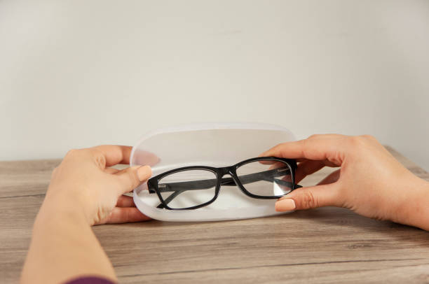 istock woman holding glasses with box 1316296991