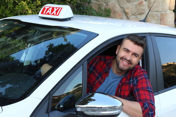 junger taxifahrer bei der arbeit - taxifahrer stock-fotos und bilder