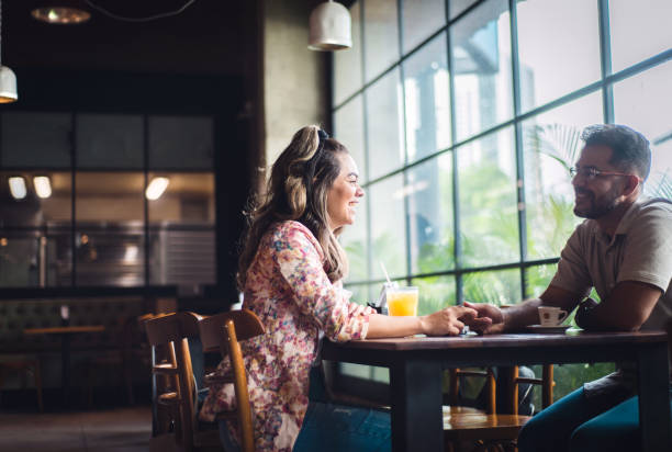 passionate couple talk at restaurant table. - couple restaurant day south america imagens e fotografias de stock