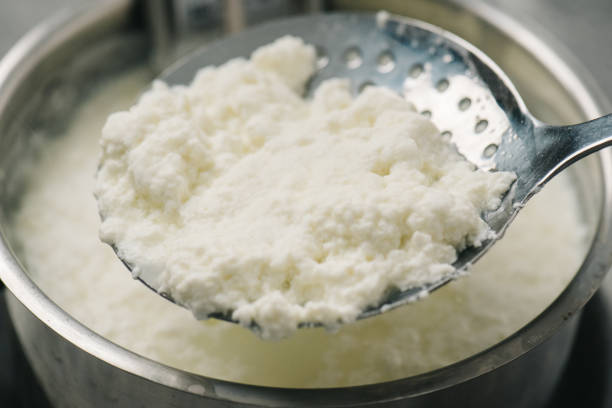istock Homemade ricotta cheese on a slotted spoon 1316302217