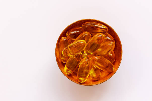 istock Yellow pills or tablets in a small plate on a white background. 1316303534