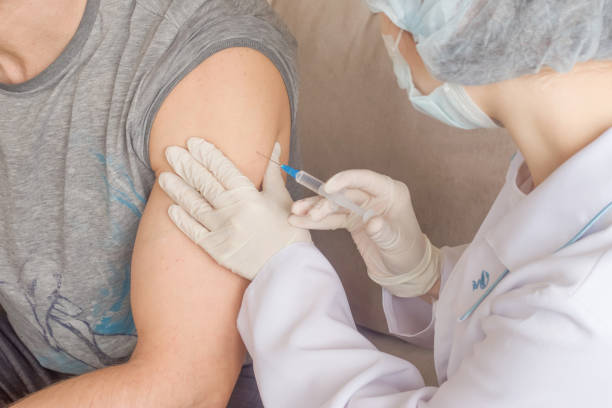 istock A nurse makes a vaccination to a man indoors 1316303871