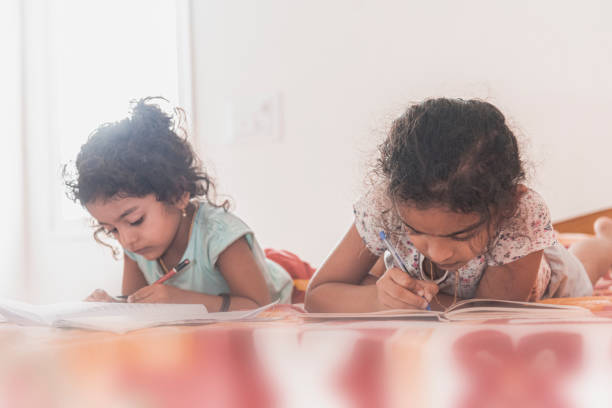 istock baby girls reading 1316304861