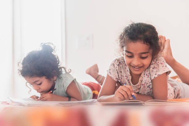 istock baby girls reading 1316304876