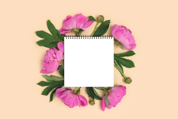 istock Notepad mockup with wreath made of peony flowers. 1316306126