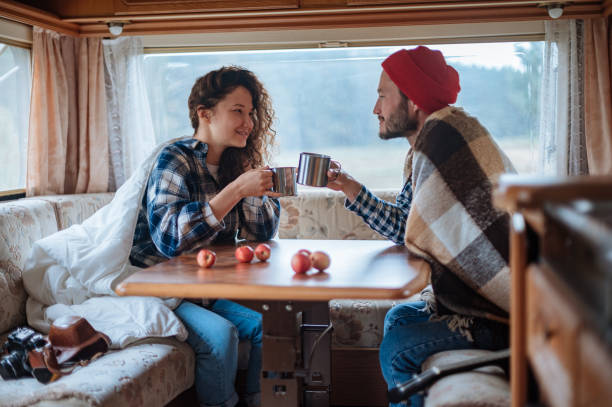 istock Couple sitting at a table in a motorhome and drinking tea. 1316306694