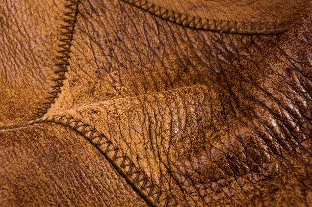 istock Old vintage genuine soft brown leather texture background, top layer with pores and scratches, macro, close-up 1316307548