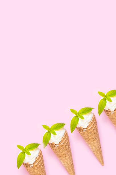 istock Mint vanilla ice cream with in a waffle cone with mint leaves on a pink plain background. 1316307607