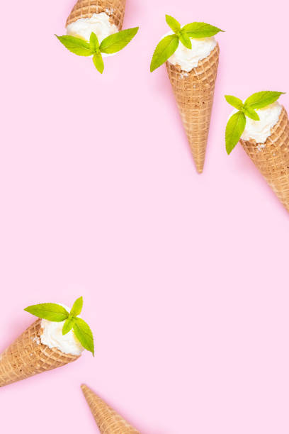 istock Mint vanilla ice cream with in a waffle cone with mint leaves on a pink plain background. 1316307610