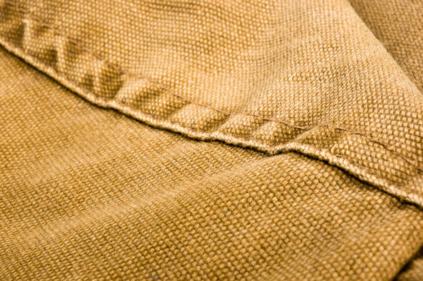istock clothing items stonewashed cotton fabric texture with seams, clasps, buttons and rivets, macro 1316308278