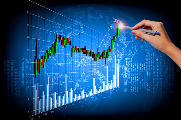 istock A woman's right hand poked a pen on a fast-growing stock chart. Globe background and blurred lights 1316310090