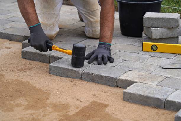 istock A craftsman lays concrete paving stone blocks on sand. 1316310983