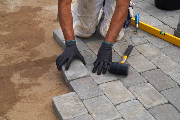 istock A craftsman lays concrete paving stone blocks on sand. 1316311808