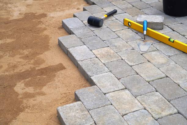istock A craftsman lays concrete paving stone blocks on sand. 1316311850