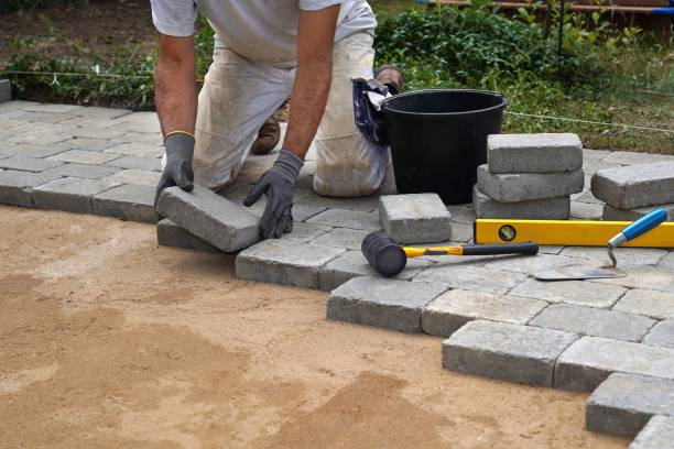 istock A craftsman lays concrete paving stone blocks on sand. 1316311898