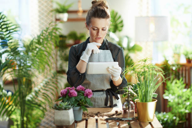 istock pensive woman in rubber gloves in sunny day using tablet PC 1316312611