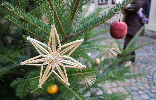 Straw star as decoration on a Christmas tree