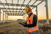 Architect using digital tablet at construction site
